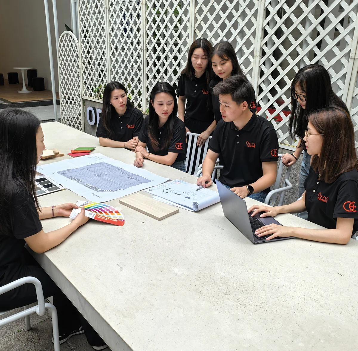 Benson design team reviewing custom kiosk drawings, materials, and project details