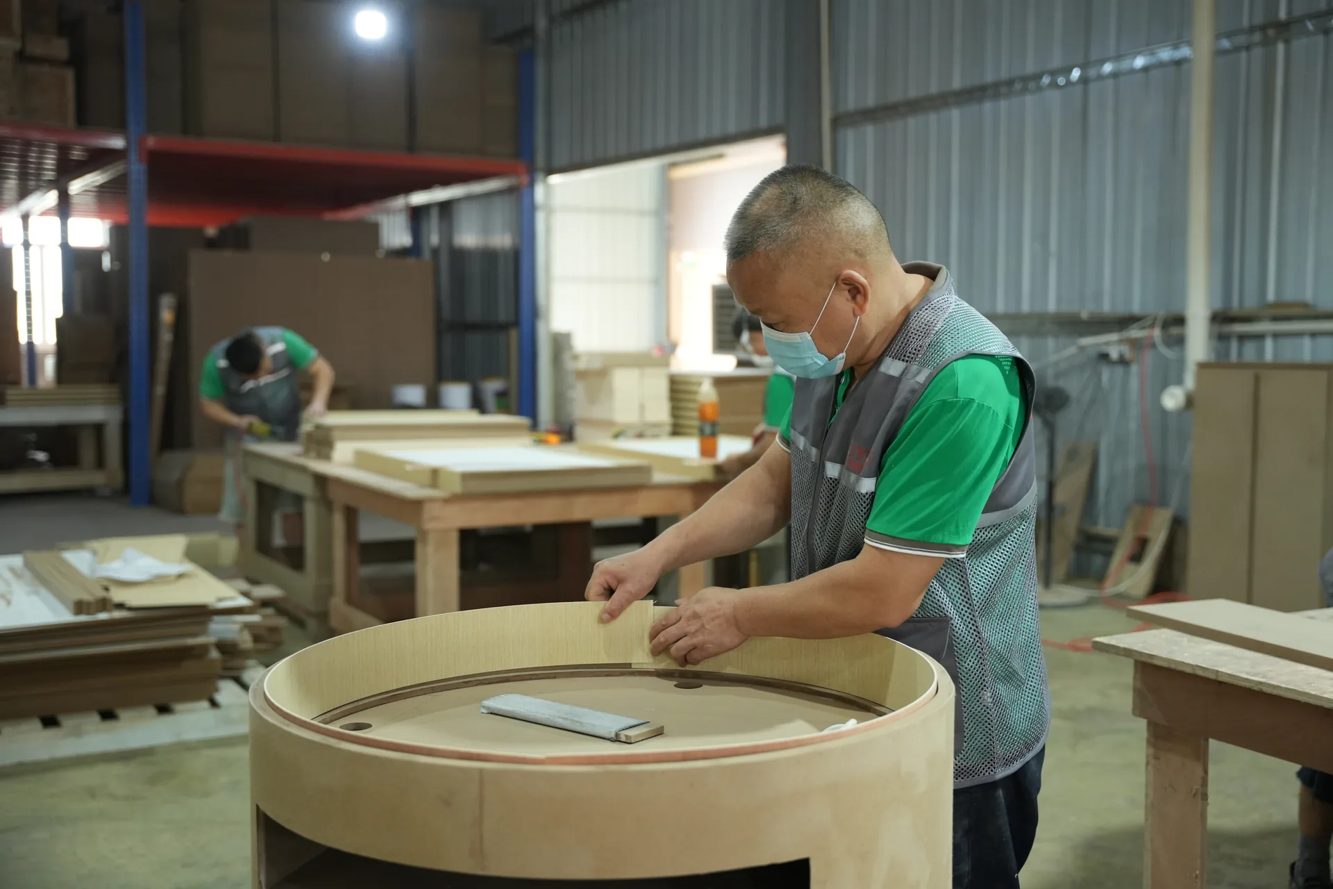 Benson woodworker shaping a curved custom retail fixture in the workshop