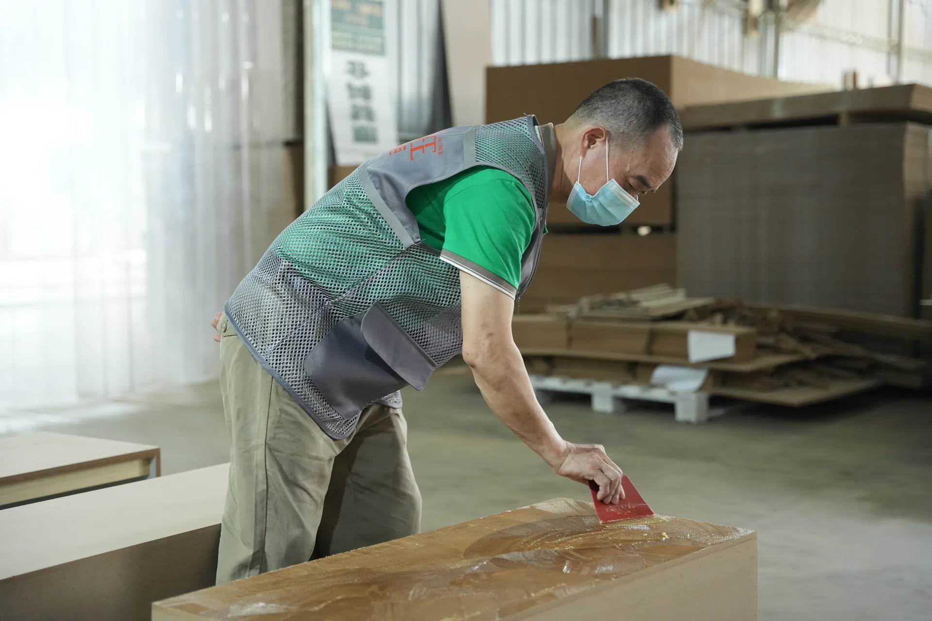Benson workshop craftsman applying material during custom fixture production